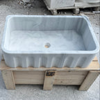 White stone sink on a wooden pallet outdoors