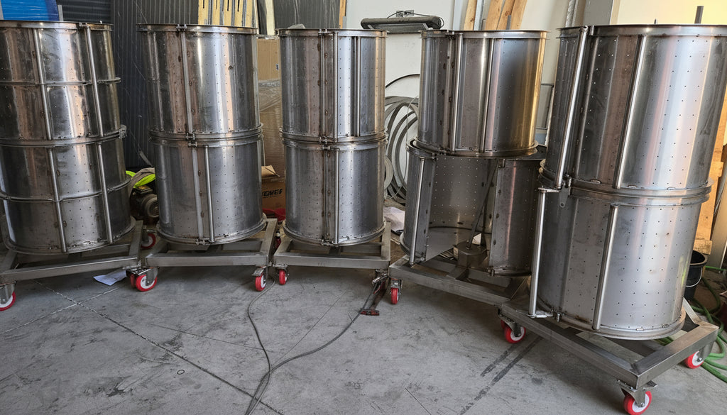 Set of metal drums on wheels in a workshop setting